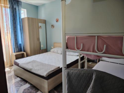 a bedroom with two bunk beds and blue walls at Giomari in Shekhvetili