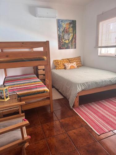 a bedroom with two bunk beds and a rug at Monte Santo in Montargil