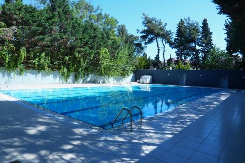 a swimming pool in a backyard with trees at Karev Sport Hotel in Gümüşyaka