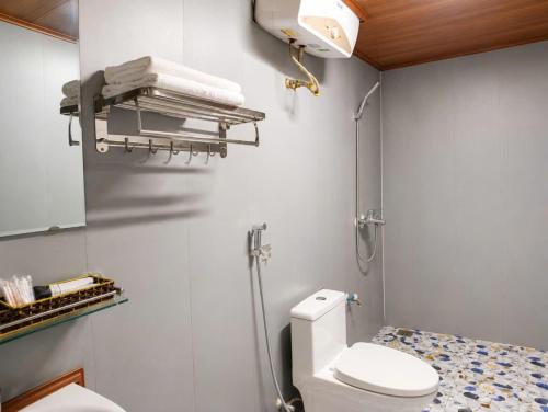 a bathroom with a toilet and a towel rack at Haven Kitchen & Cafe in Nguyễn Thôn