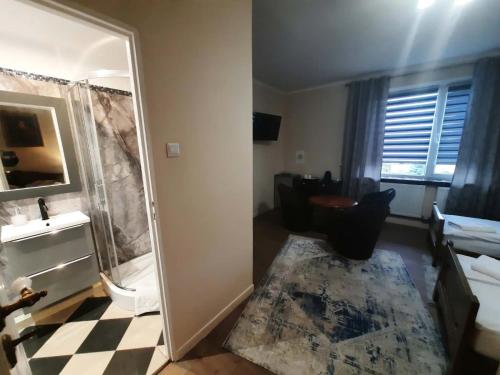 a bathroom with a shower and a toilet and a mirror at Hotel i Apartamenty Rosa in Przemyśl