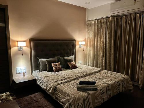 a bedroom with a large bed with two lamps at Spacious 4 BHK flat- 4 Beds in Indore