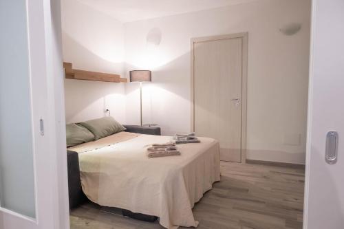 a bedroom with a bed and a sliding door at La Torre Guelfa in Iglesias