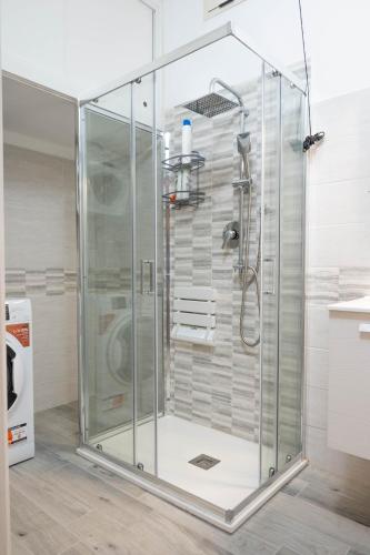 a shower with a glass enclosure in a bathroom at La Torre Guelfa in Iglesias