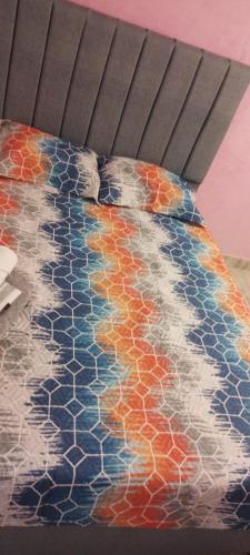 a bed with a multicolored rug on the floor at Apartamento C&B in Bello