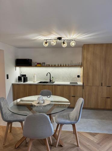 a kitchen with a table and chairs in a room at Hi Wisła in Wisła
