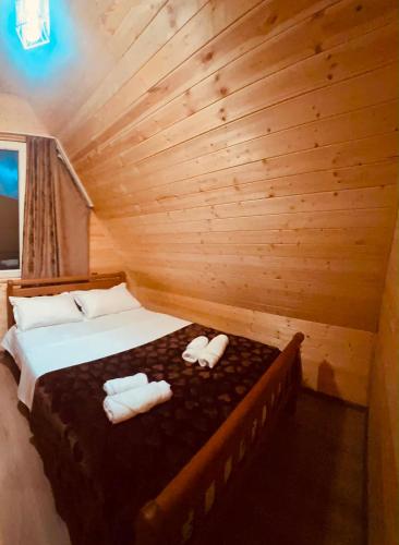 a bedroom with a bed in a log cabin at Pine House Borjomi , Mountain View in Borjomi