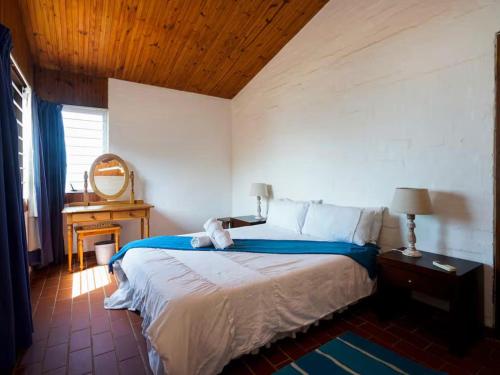 a bedroom with a large bed with a wooden ceiling at 8 Hewitt @ Tiffany's in Sheffield Beach