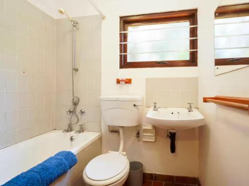 a bathroom with a toilet and a sink at 8 Hewitt @ Tiffany's in Sheffield Beach