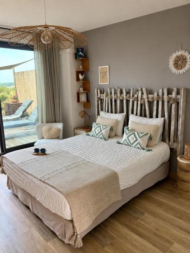 a bedroom with a large bed and a large window at Studios Nuitée en Provence in Aix-en-Provence