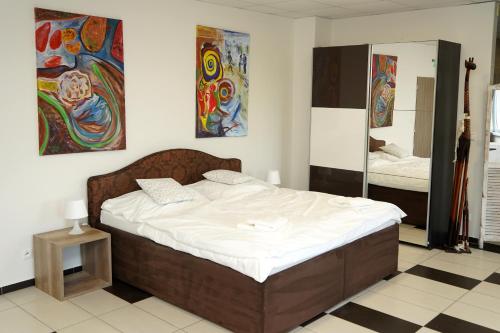 a bedroom with a large bed and a mirror at Panorama Motel -Wellness in Veľký Meder