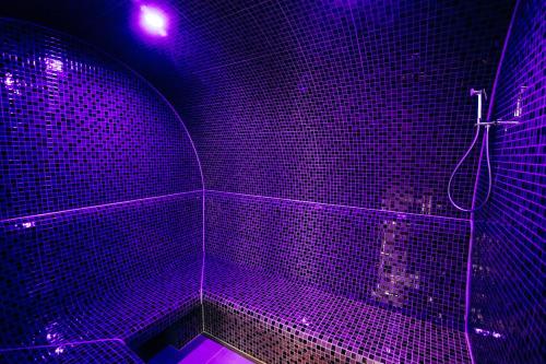 a purple room with a shower with a purple light at Kasimir Hotel & SPA in Bukovel