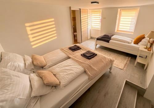 a living room with a white couch with towels on it at Mekcsey Udvar in Eger