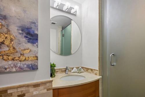 a bathroom with a sink and a mirror at Premier Ocean Lagoon Studio · Condado with Pool in San Juan