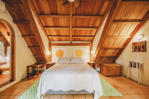 a bedroom with a bed with wooden ceilings at Casa De Columnas in Cartagena de Indias