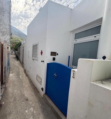 a building with a blue door on the side of it at Casa Civetta in Stromboli