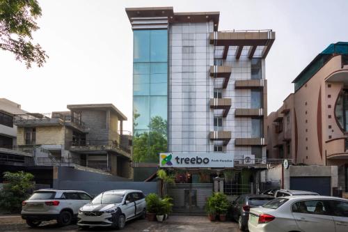 a building with cars parked in front of it at Treebo Parth Paradise in Ghaziabad