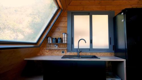 a kitchen with a sink and a window at Cabin with jacuzzi and spectacular views in Oliva