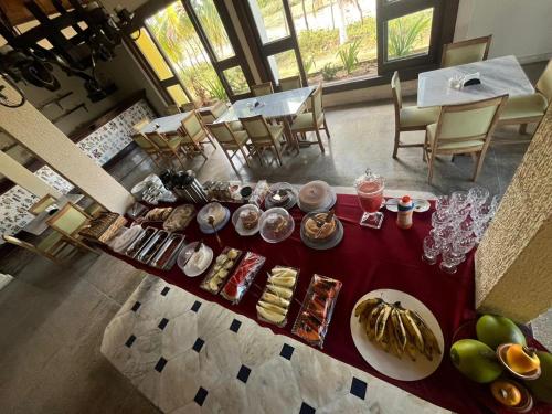 a table with plates of food on top of it at Hotel Costa do Sol in Conde