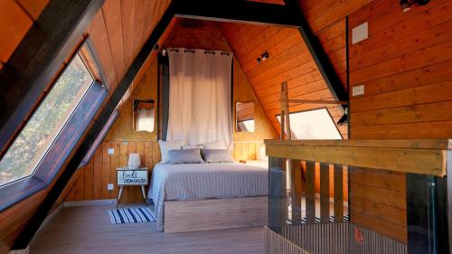 a bedroom in a tree house with a bed in it at Cabin with jacuzzi and spectacular views in Oliva