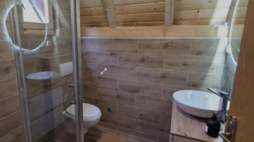 a bathroom with a toilet and a sink and a shower at Vlado Retreat in Banja Luka