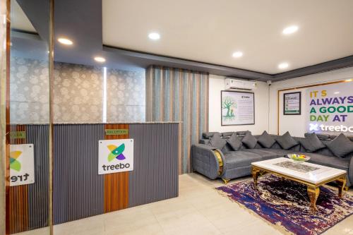 a living room with a couch and a table at Treebo Parth Paradise in Ghaziabad