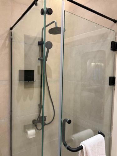 a shower with a glass door in a bathroom at IOS Village & Hotels in El Alamein