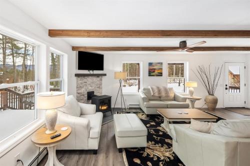 a living room with white furniture and a fireplace at Luxury Retreat, Views, Near Whiteface, Lake Placid in Jay