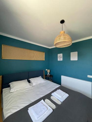 a bedroom with a bed with two towels on it at Aura House in Tsalka