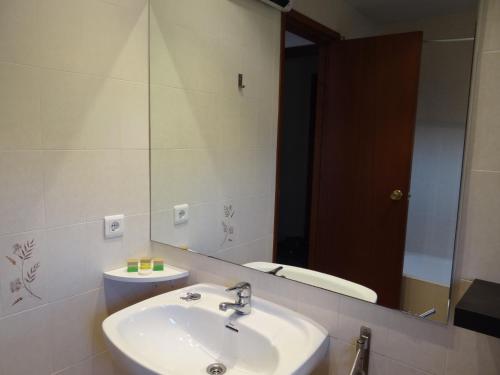 uma casa de banho com um lavatório, um espelho e um WC. em Hostal Tivissa em Tivissa