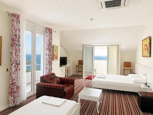 a living room with a bed and a couch at Vila Duraku in Sarandë