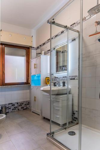 a bathroom with a sink and a glass shower at Gold House in Lungro
