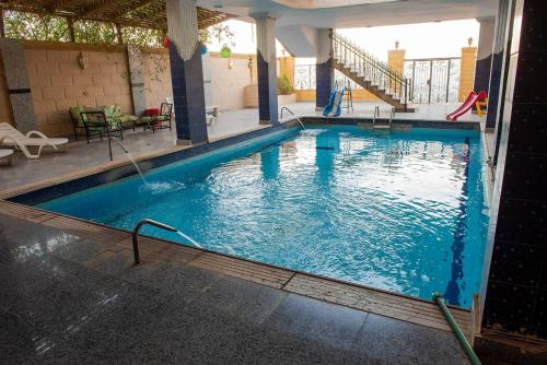 a large swimming pool with blue water at Pyramita luxury hotel in ‘Ezbet `Abd el-Ḥamîd