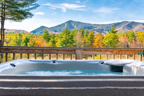 a jacuzzi tub with a view of the mountains at Mountain Home, Views, Near Whiteface, Lake Placid in Wilmington