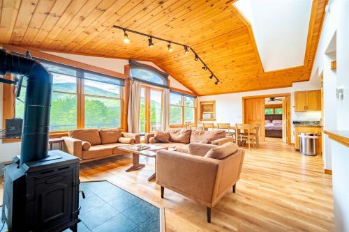 a living room with a couch and a stove at Breathtaking Views Near Lake Placid and Whiteface in Wilmington