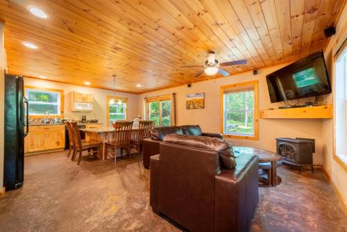 a living room with a couch and a table at Adirondack Retreat Near Whiteface and Lake Placid in Wilmington