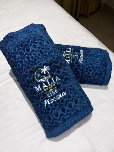 a blue towel sitting on top of a bed at FLAT RESORT LUXO MALIA 215E- Porto de Galinhas - Muro Alto in Porto De Galinhas