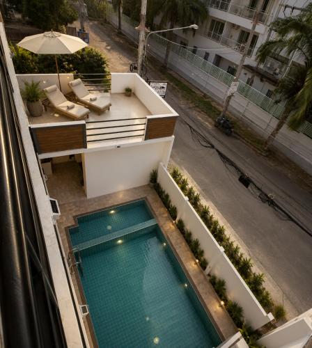 a swimming pool on the balcony of a building at Sunset Beach Inn in Hua Hin
