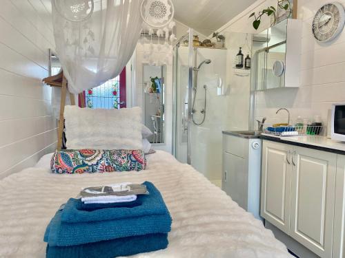 a small bathroom with a bed and a shower at Studio 59 Newport sleeps1 in Newport