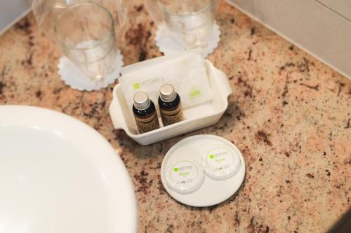 a counter with two bottles of essential oils and glasses at Amethyst in Sovata