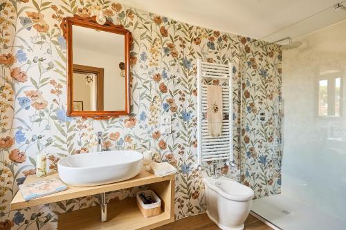 a bathroom with a sink and a tub at CasaBianchini Charming Home Val d'Orcia in Monticchiello
