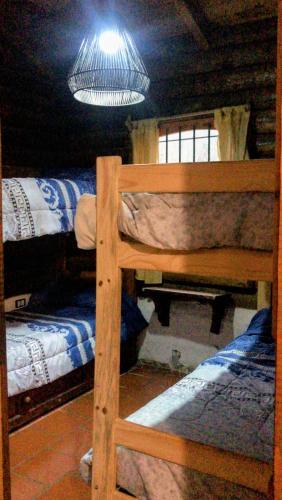 a room with two bunk beds and a light at El Rancho in Villa Giardino