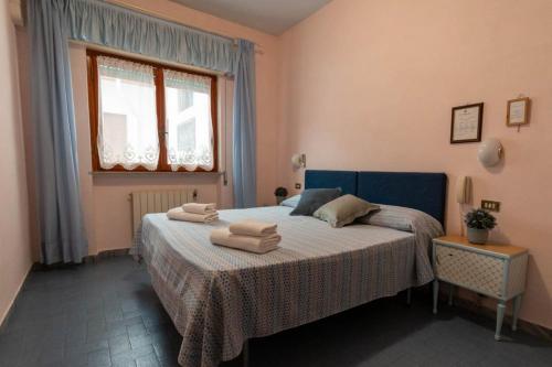 a bedroom with a bed with towels on it at Meublè Andrea Doria in Torre del Lago Puccini