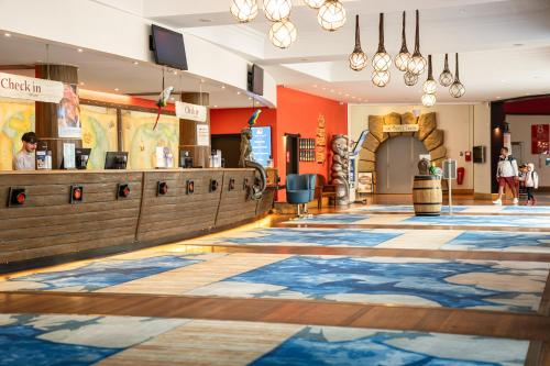 a lobby of a store with a large rug on the floor at Explorers Hotel Marne-la-Vallée in Magny-le-Hongre