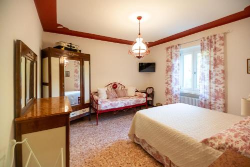 a bedroom with a bed and a dresser and a mirror at Carlo Alberto B&B in Gavi