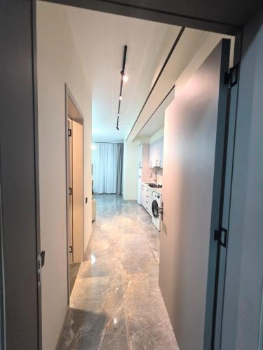 a hallway with a door open to a kitchen at ,,KaKalo'' Apartments in Kobuleti