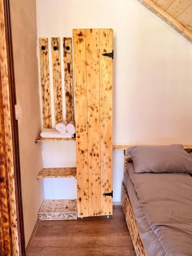 a room with two beds in a room with wooden walls at Montenegro pines in Bistrica Lipovska