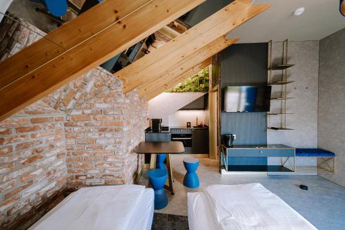 a living room with a brick wall and a kitchen at Apartamenty Wieliczka in Wieliczka