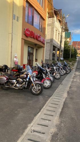 a row of motorcycles parked in front of a store at Pensiunea Panoramic - Transalpina Rânca in Ranca