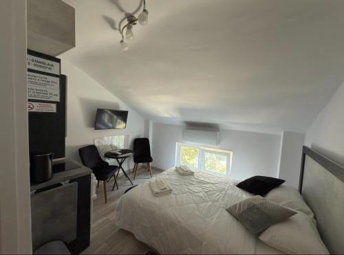a bedroom with a bed and a table and chairs at Storm in Varna City